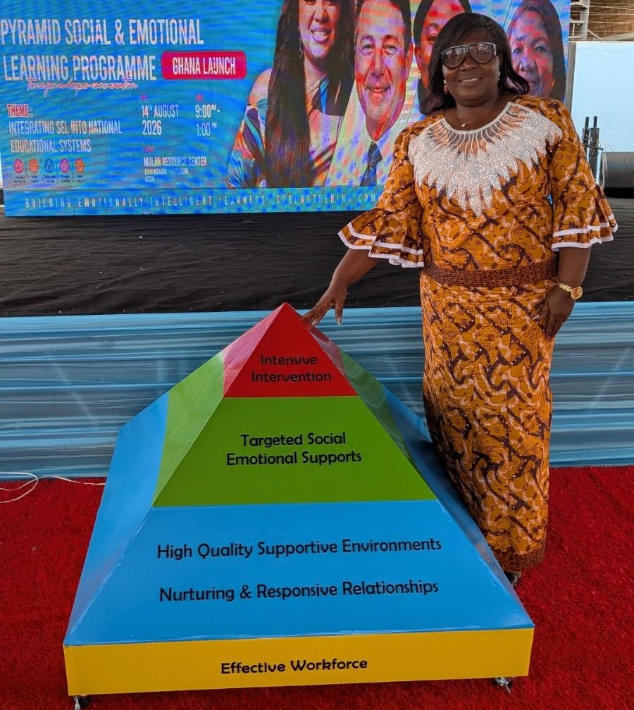Dr. Cynthia Addoquaye Tagoe beside the Pyramid Model display at the Ghana launch